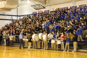 Saint Viator High School Band Director Vince Genualdi leads the band in playing the school's fight song at a 2015 pep rally