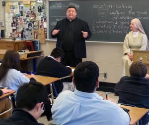 Fr. Jason Nesbit, CSV, talks to students at Bishop McNamara High School about vocations during Catholic Schools Week