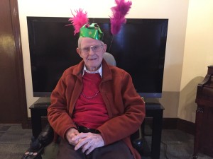 Fr. Frank White, 97, enjoys the Mardi Gras party