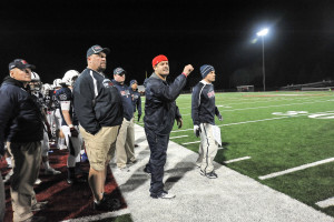 Fr. Dan Hall, far left, coaching on the sidelines