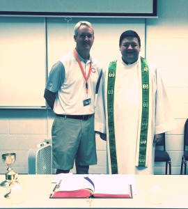 Brian McCaskey of the Chicago Bears poses after Mass with Fr. Jason Nesbit