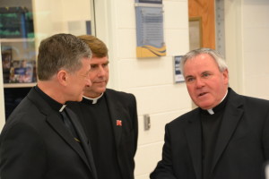 Archbishop Blase Cupich, left, meets with Fr. Corey Brost and Fr. Thomas von Behren, right
