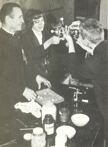 Fr. Eugene Lutz, CSV, works with students during a 1964 chemistry lab