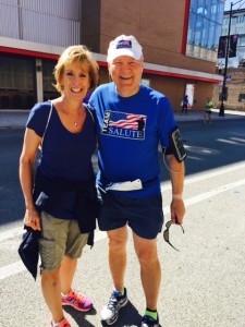 Fr. Dan Hall, pausing at Mile 17 of the Chicago Marathon with one of his fans, Saint Viator High School Registrar, Rose Ruffatto