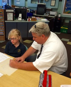 Br. Dan Tripamer, CSV, helps a student with math homework