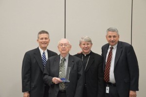 Br. Leo Ryan, CSV, second from left accepts award from Bishop R. Daniel Conlon, second from right and finance council officers