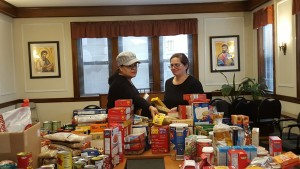 Pre-Associates Susana Tellez, left, and Ivy Vera coordinated a food drive during Thanksgiving week for local families