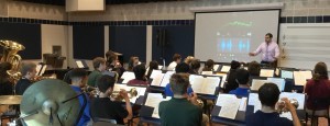 Mr. Vince Genualdi uses technology to help members in Saint Viator's band tune their instruments