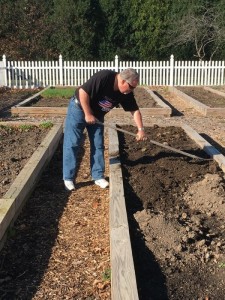 Associate Tim Schwarz spreads new soil across his bed