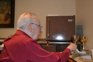 Br. Don Houde, CSV, lovingly polishes a pair of chalices to be donated