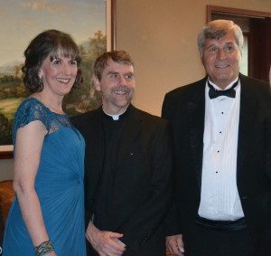 Kate Costello, left and Chuck Heinrich, right, pose with Fr. Corey Brost, CSV, at Night of Lion. Both were named distinguished alumni