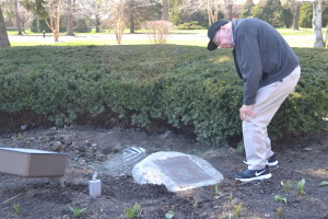 Fr. Charles Bolser reads the plaque that was dedicated nearly 20 years ago to his ancestors who served in the military