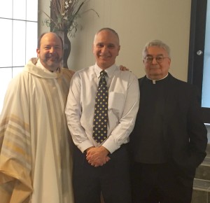 Fr. Dan Belanger, CSV, left and Fr. Richard Pighini, CSV, right congratulate Terry Granger on being named Principal of the Year