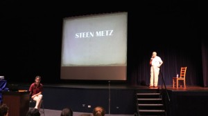 Steen Metz presenting at Saint Viator High School, with his granddaughter, Sarah McDermott '19, helping with slides