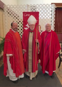 Fr. Dan Belanger, left, and Fr. James Fanale, right, assisted Abbot Hugh Anderson during the confirmation