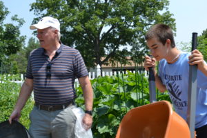 Fr. Dan Hall works with campers at the Province Center garden during the 2014 Service & Song Camp