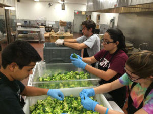 Teens from St. Thomas More help prepare food for Catholic Charities at the 2015 Camp LIGHT