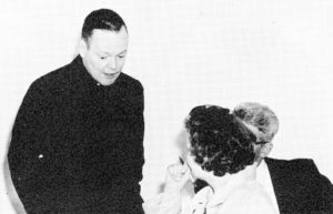 Fr. Ed Anderson, CSV, chats with parents in 1964 at Alleman High School 