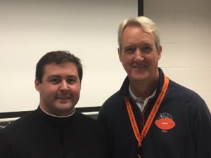 Br. Peter Lamick and Brian McCaskey of the Bears front office