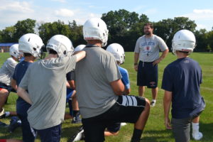 Br. Peter Lamick gives a pep talk to some of the freshmen team