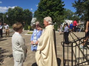 Fr. Richard Pighini, CSV, pastor, meets with parishioners after the dedication