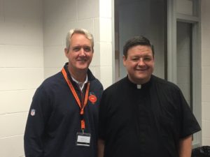 Fr. Jason Nesbit with Brian McCaskey of the Chicago Bears front office, after saying Mass at training camp