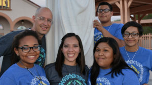 Daisy Morales, center, with VYC delegates in 2014, and delegation leader, Jim Dippold, upper left