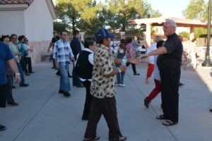 Fr. Bill Haesaert greets parishioners as they head to the Taste