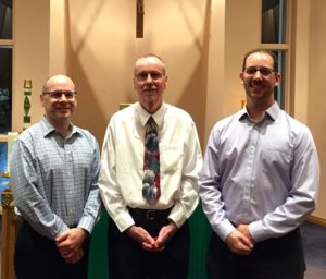 Associate Brian Barrett, right, with Associates John Keating, left, and Don Wells, center, during their re-commitment ceremony in 2015