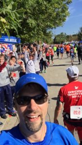 Br. John takes a selfie at a water station manned by members of the SVHS cross country team