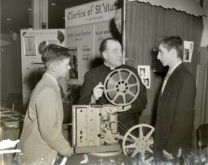 Fr. Francis T. Williams promotes "The Search" at a vocations fair in 1956