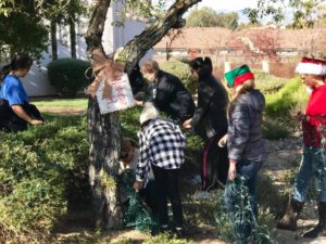 Members of the Women's Guild work together to decorate their tree