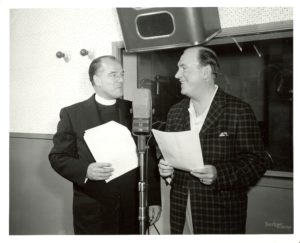 Fr. Francis T. Williams goes over the script of "The Search" with its narrator, actor Pat O'Brien in 1956