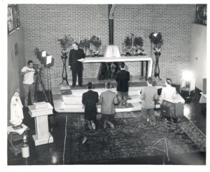 Fr. Williams, at left in back, directs the "Habit" scene in the chapel in the Viatorian Province Center